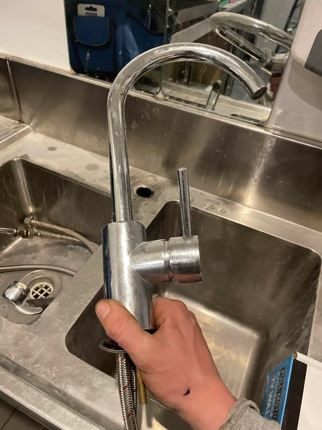 Repairing a leaking mixer tap at the sink